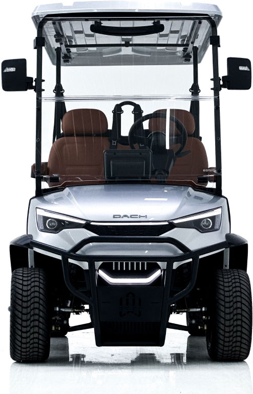 Front view of a silver DAC golf cart with clear windshield, two brown seats, and side mirrors, against a white background.
